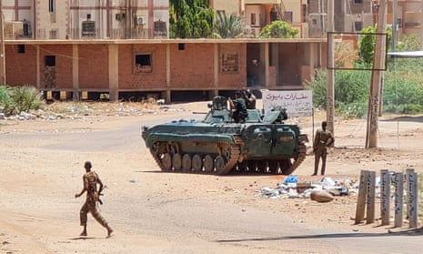 Sudanese army soldiers and a tank on an otherwise deserted street in southern Khartoum