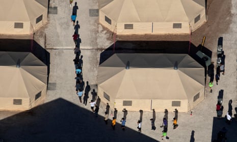 Immigrant children are led by staff in single file between tents at a detention facility in Tornillo, Texas<br>Immigrant children are led by staff in single file between tents at a detention facility next to the Mexican border in Tornillo, Texas, U.S., June 18, 2018. Picture taken June 18, 2018 REUTERS/Mike Blake TPX IMAGES OF THE DAY