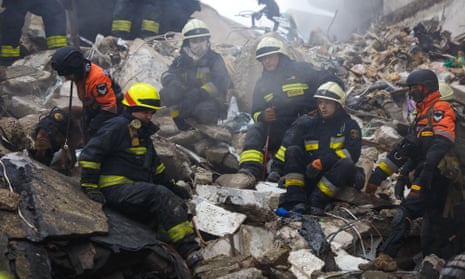 Rescuers at the scene of the rocket attack in Dnipro.