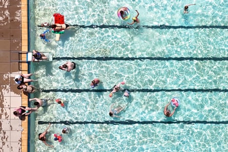 An aerial view of a lido with people swimming and playing
