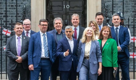 Regional mayors standing together with the black door to 10 Downing Street in the background