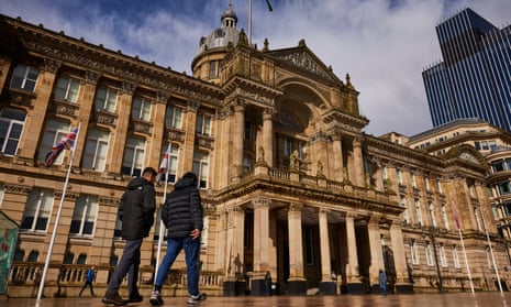 People walk past the Council House in Birmingham