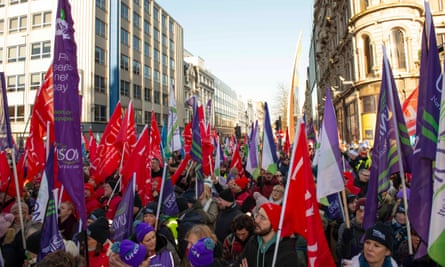 Striking workers march towards Belfast City Hall.