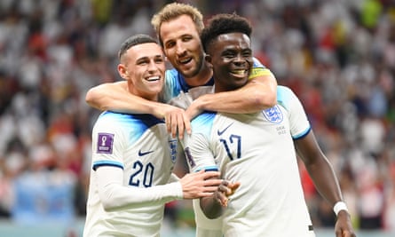 Bukayo Saka (right) celebrates with Phil Foden and Harry Kane after scoring England's third goal against Senegal.