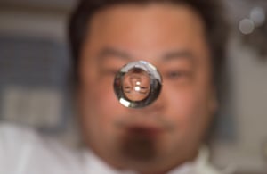 Expedition 10 commander Leroy Chiao is reflected in a water sphere on board the International Space Station in 2004.
