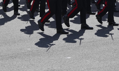 The shadows of Royal Military College graduates are seen as they march
