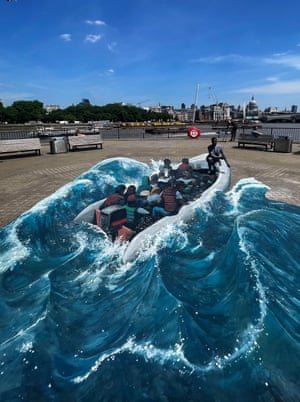 London, UK The Ethiopian refugee and long-distance runner Eskander Turki kneels next to an artwork on London’s South Bank, depicting his journey to the UK from Ethiopia, created by the street artists 3D Joe and Max