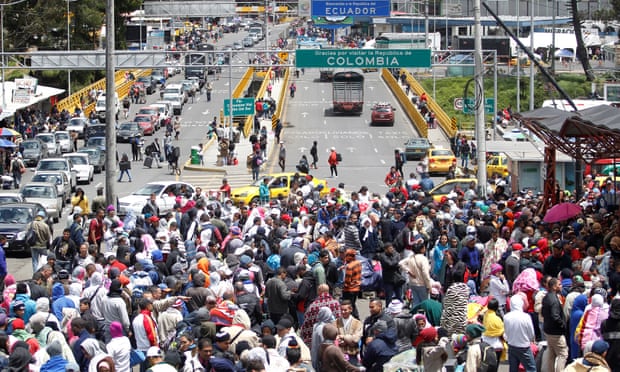 Venezuelans queue to register their exit from Colombia before entering into Ecuador at Rumichaca Bridge. 
