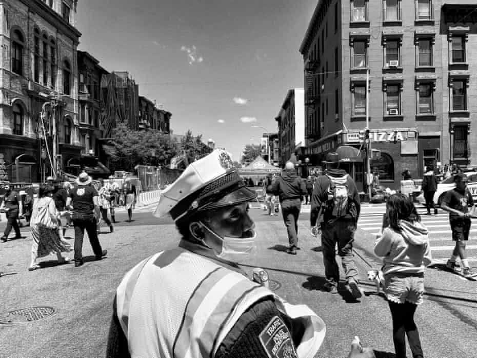 A traffic officer directs pedestrians during a fair in Brooklyn, New York
