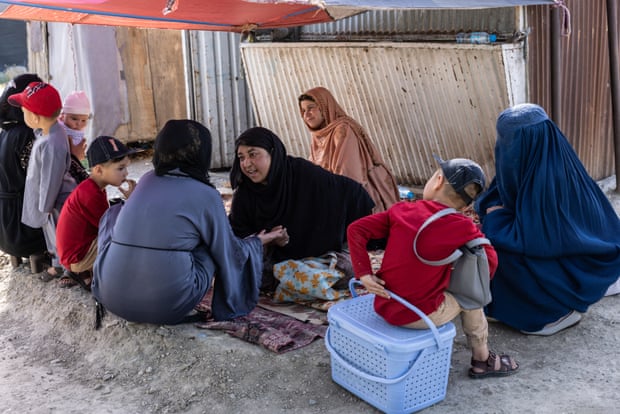 Sabsa Gul, 40, is palm reading. ‘Women are now asking me to help them leave the country. They don’t want to stay in Afghanistan any longer,’ she says.