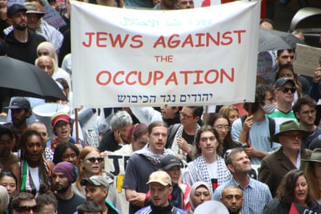 Protestors holding a sign that reads 'Jews against the occupation'.