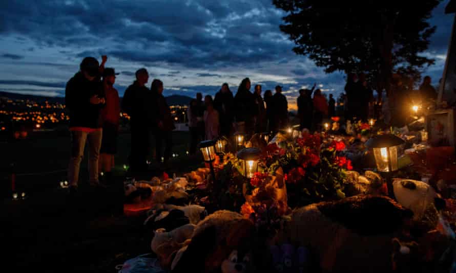 People gather outside a former Indigenous school near Kamloops in British Columbia, where the remains of 215 children were found, earlier this month.