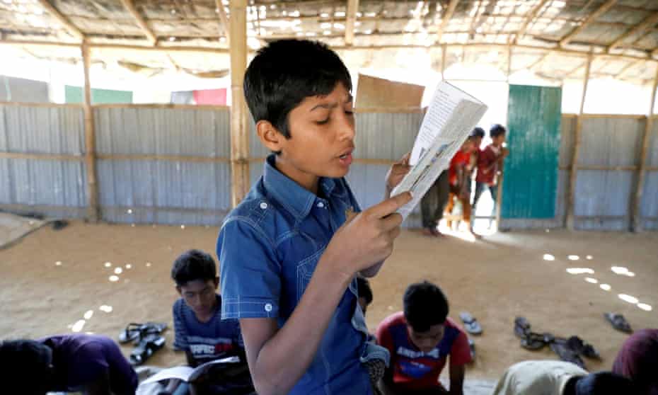 A child reads a book in a makeshift school run by Rohingya teachers in Kutupalong refugee camp in Cox’s Bazar, Bangladesh.