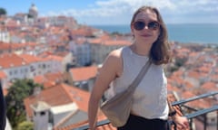 Amelia Williams in a holiday snap, leaning on railings with a sunny seaside city below