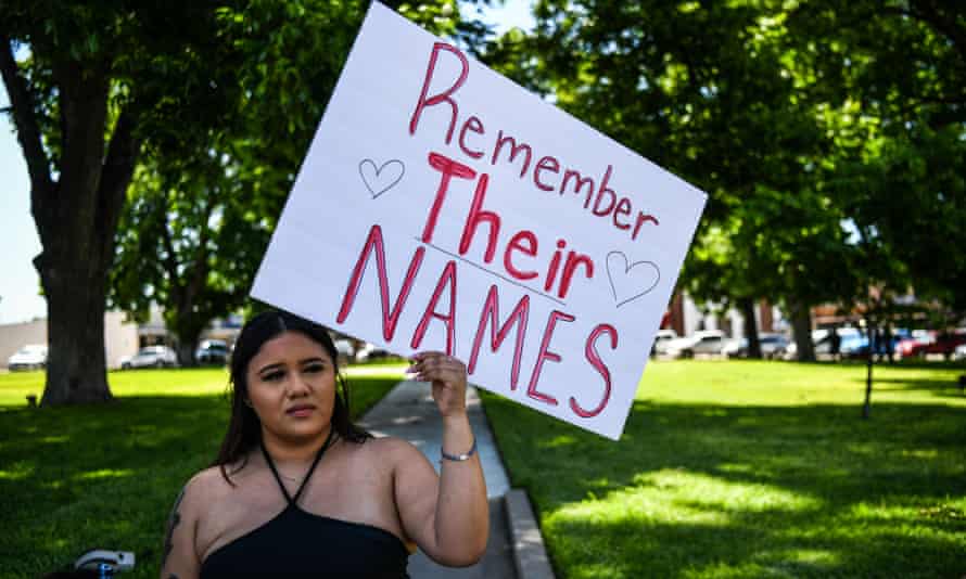 A resident holding a placard that reads ‘Remember their names’ as people grieve for the victims of the mass shooting at Robb elementary school in Uvalde, Texas.