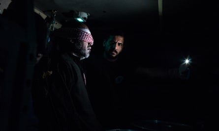 A member of the counter-terrorism force escorts an Isis suspect into the interrogation centre.