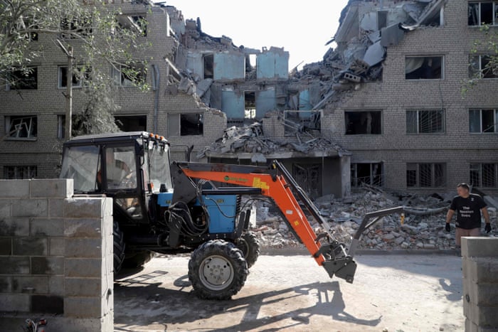 Communal workers remove the debris of a student hostel destroyed as a result of shelling in Mykolaiv.