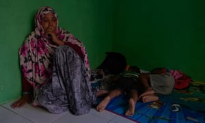 A homeless Somalian refugee sits with her sick children in a fellow refugee’s room in Jakarta in 2018. Refugees in Indonesia barely survive often relying on charity or the help of their families and are unable to work legally.