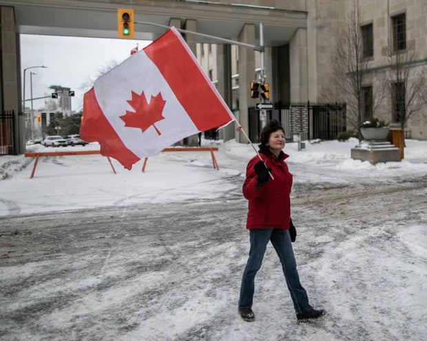 Someone holding the Canada flag in the snow