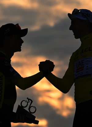 Second placed rider Jonas Vingegaard of Team Visma Lease a Bike (left) congratulates Tour winner Tadej Pogacar.