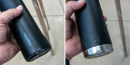 close-up of man holding water bottles with dents and scuffs on bottom