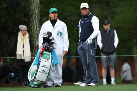 Hideki Matsuyama talks with his caddie Shota Hayafuji on the 14th.