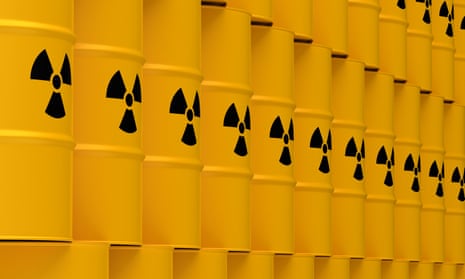 Stacks of yellow tin drums with nuclear waste warning symbol