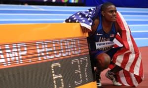 Christian Coleman poses in front of his winning time – a championship record – after winning the 60m final at the world indoors in Birmingham on Saturday.