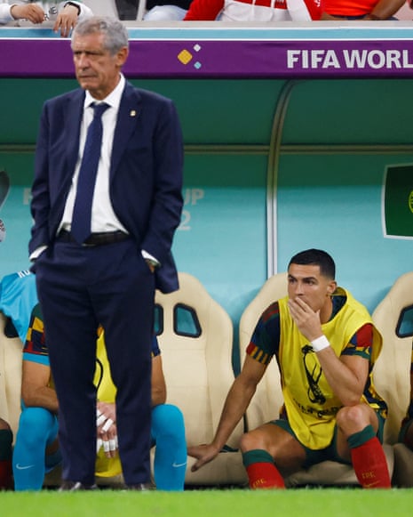 Portugal coach Fernando Santos watches on as Cristiano Ronaldo waits on the substitutes bench.