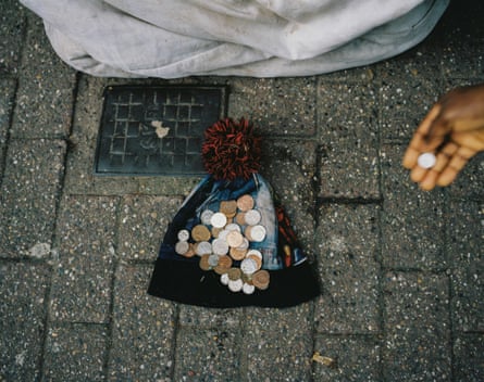 A hat on the ground collects small change.