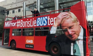 An impersonator of Britain’s new prime minister, Boris Johnson waves from a ‘Boris lie-buster’ bus parked in Canary Wharf, in London.