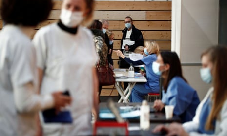 Healthcare workers wait to receive the Pfizer-BioNTech Covid-19 vaccine at a vaccination centre in a gymnasium in Taverny near Paris.
