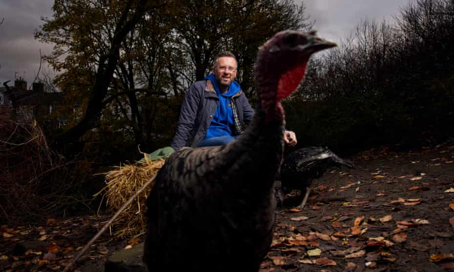 Portrait of farmer Paul White with a turkey