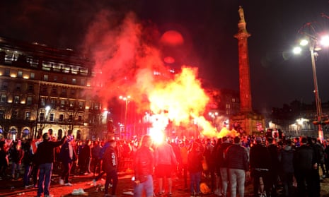 Rangers fans set off flares in Glasgow’s George Square as they celebrate their team winning the Scottish Premiership title.