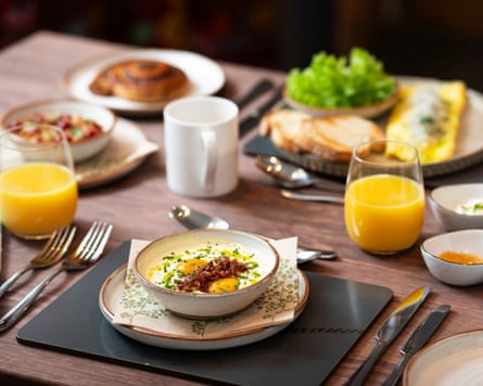 Breakfast of an egg dish, toast, pastries and orange juice laid out on a table at Stone Barn, County Cork, Ireland.