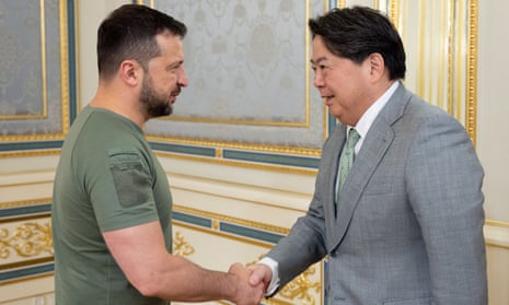 Ukraine’s president Volodymyr Zelensky shaking hands with Japan’s foreign minister Yoshimasa Hayashi prior to their meeting in Kyiv.