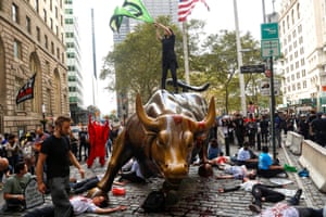 Extinction Rebellion climate crisis activists protest at New York City’s famous Charging Bull statue.