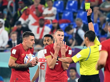 Strahinja Pavlovic is shown a yellow card by referee Fernando Rapallini.