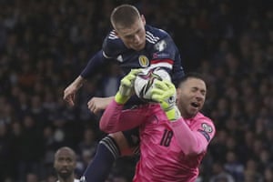 Israel’s goalkeeper Ofir Marciano gathers the ball under pressure from Scotland’s Scott McTominay.