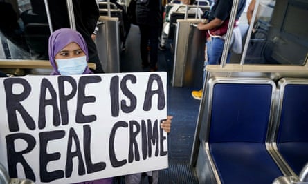 A woman holds a sign on a train reading ‘rape is a real crime’ during a rally in Philadelphia on 30 October.