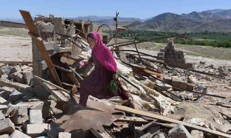 An Afghan girl walks amid the rubble of shops in Shadel Bazar after the US military dropped a GBU-43 Moab bomb in Achin district of Nangarhar province, Afghanistan.
