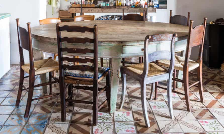 Mix and lucifer chairs astir the eating table.