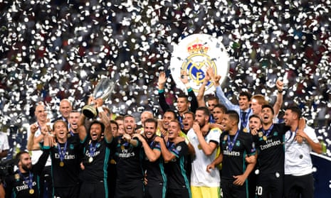 Real Madrid’s players celebrate with the UEFA Super Cup trophy after beating Manchester United 2-1 in Skopje