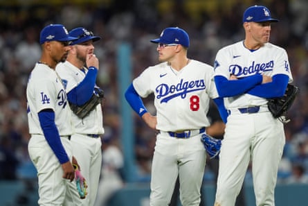 Mookie Betts, Max Muncy, Kiké Hernández and Freddie Freeman stand during a Dodgers game.