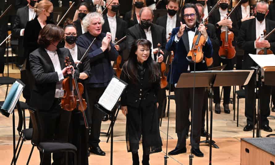 Unsuk Chin (centre) is applauded following the world premiere of her Violin Concerto No 2, Scherben der Stille at the Barbican, London.