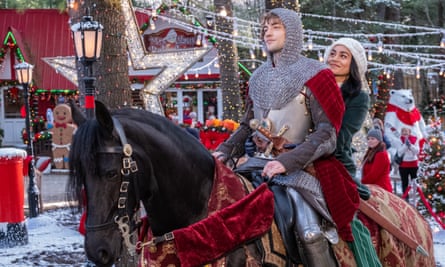 She rides behind him on his horse through a Christmassy town