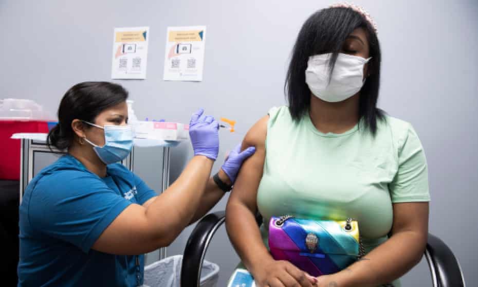 Shakia Jones gets a dose of the Pfizer Covid-19 vaccine from health provider Alexandra Moran in Maryland. 