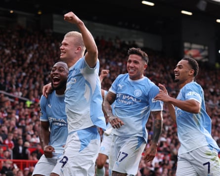 Footballers celebrating a goal.