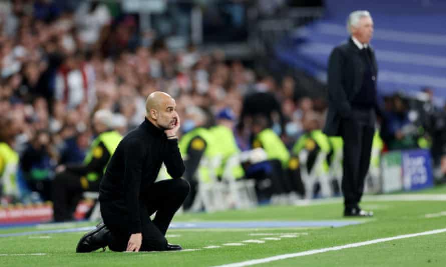 Pep Guardiola and Carlo Ancelotti observe from the touchline.