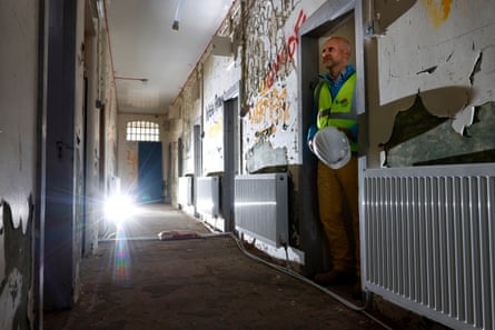 The chief operating officer of Lar Housing Trust, Mikko Ramstedt, in what was the jail of the Naval Barracks where the heat pump is at work, heating radiators.